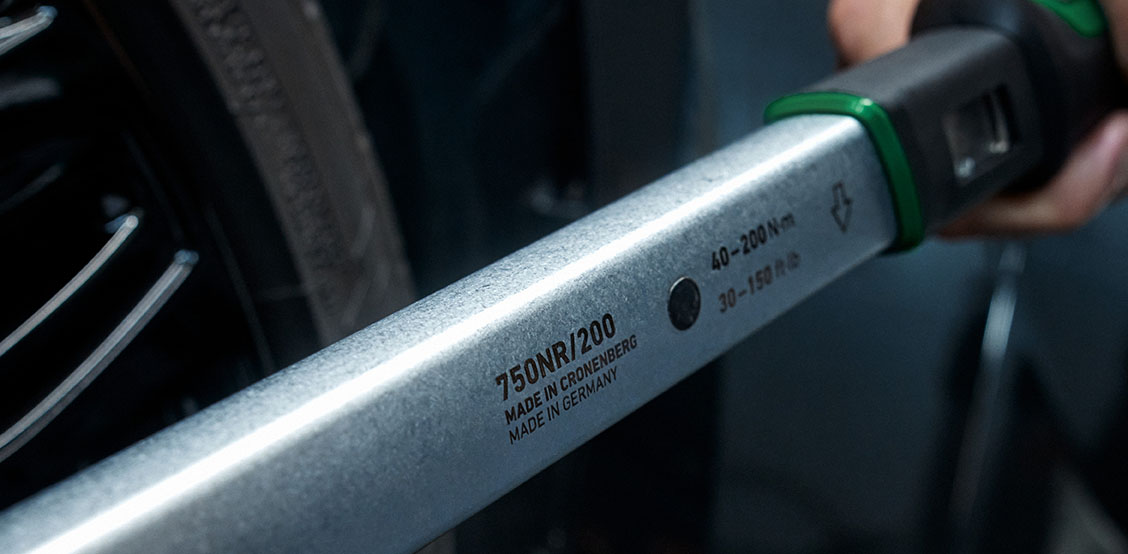 Close-up of a torque wrench tightening wheels